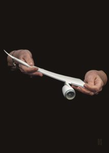 2 hands holding a model of an aircraft engine and wing