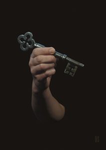 one hand holding large metal key