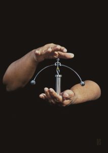 two hands holding a silver balance toy